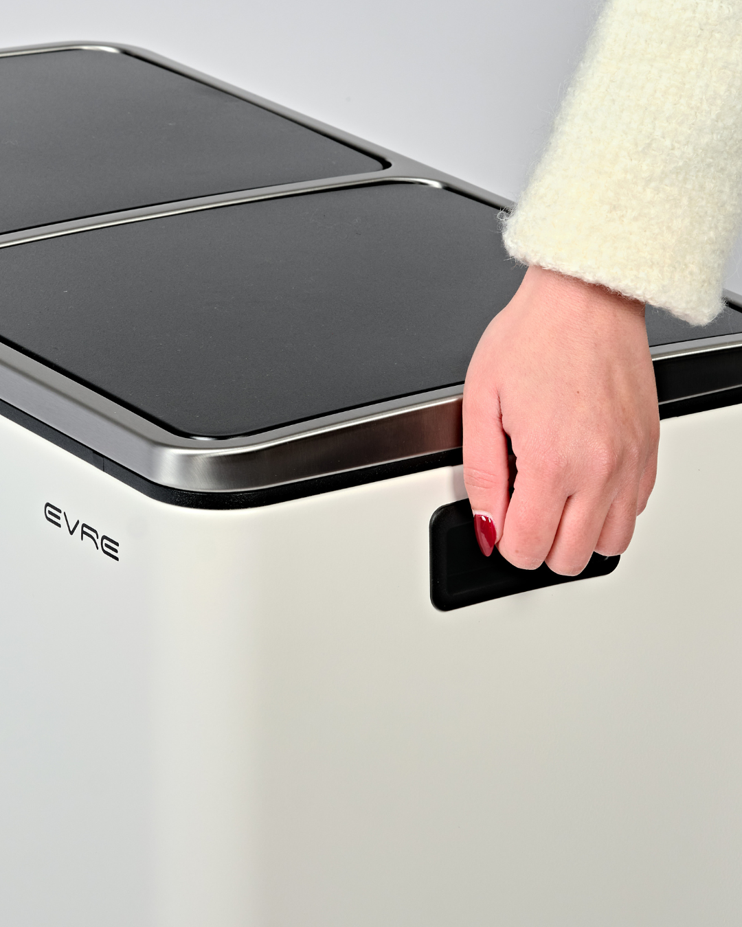 Lifting a white bin with built-in handles