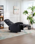 Black recliner chair in a modern living room with plants and decor.