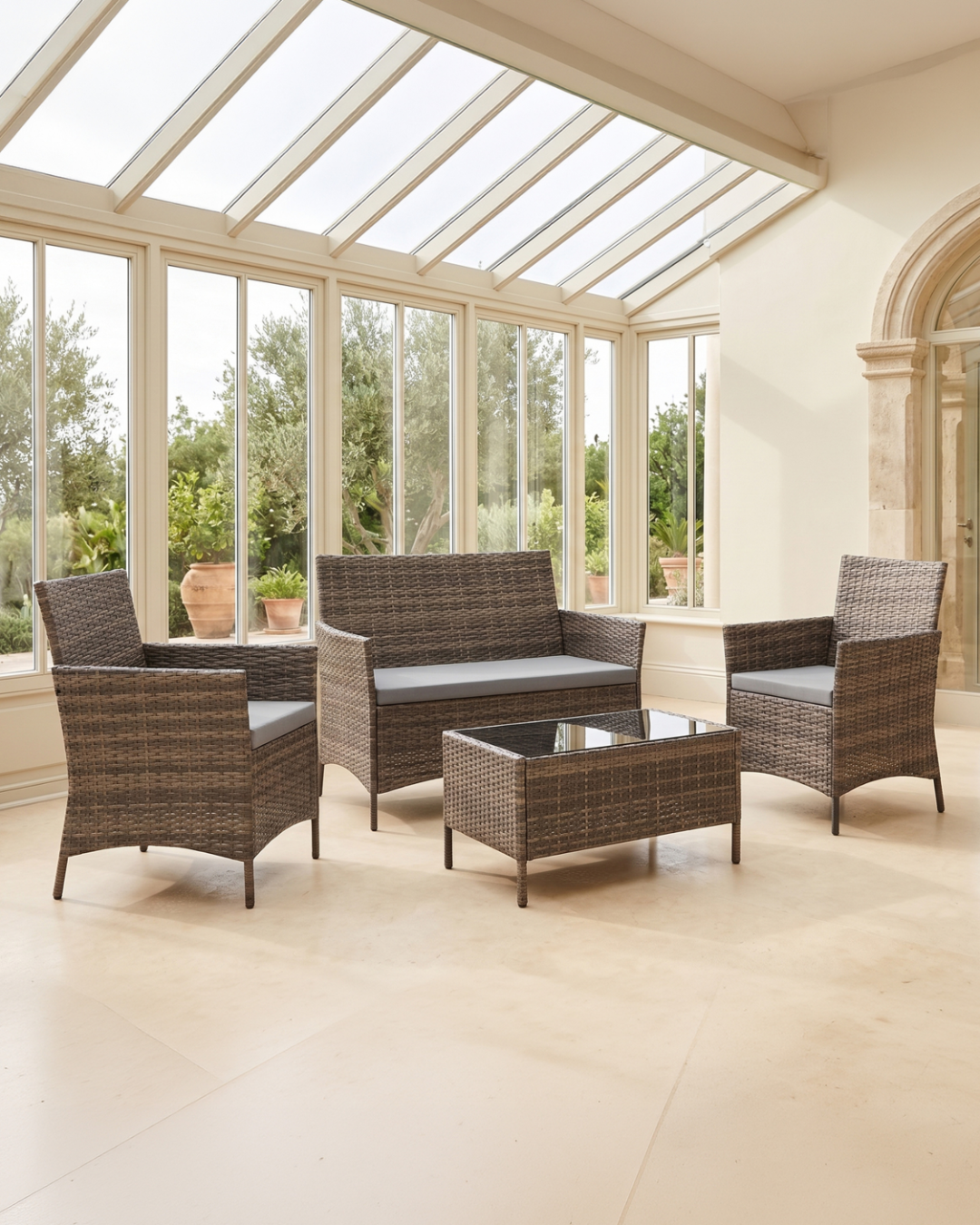 Outdoor furniture set in a sunroom with large windows