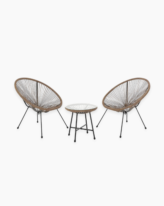 Two wicker chairs and a small table in a cosy bistro set