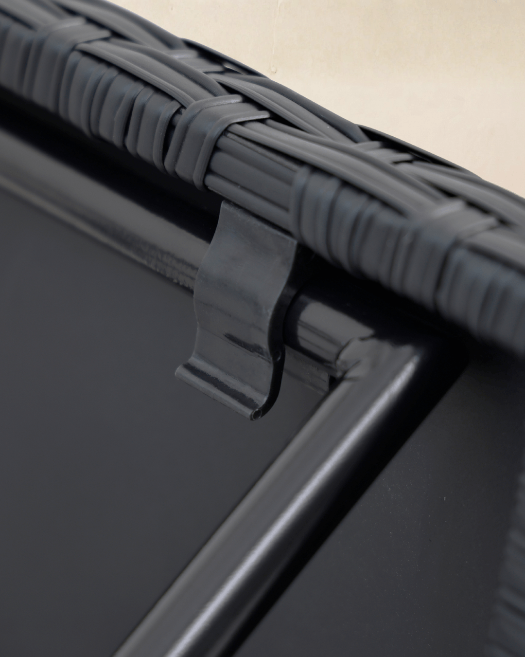 Close-up detail of a collapsible garden bistro table with black rattan tabletop