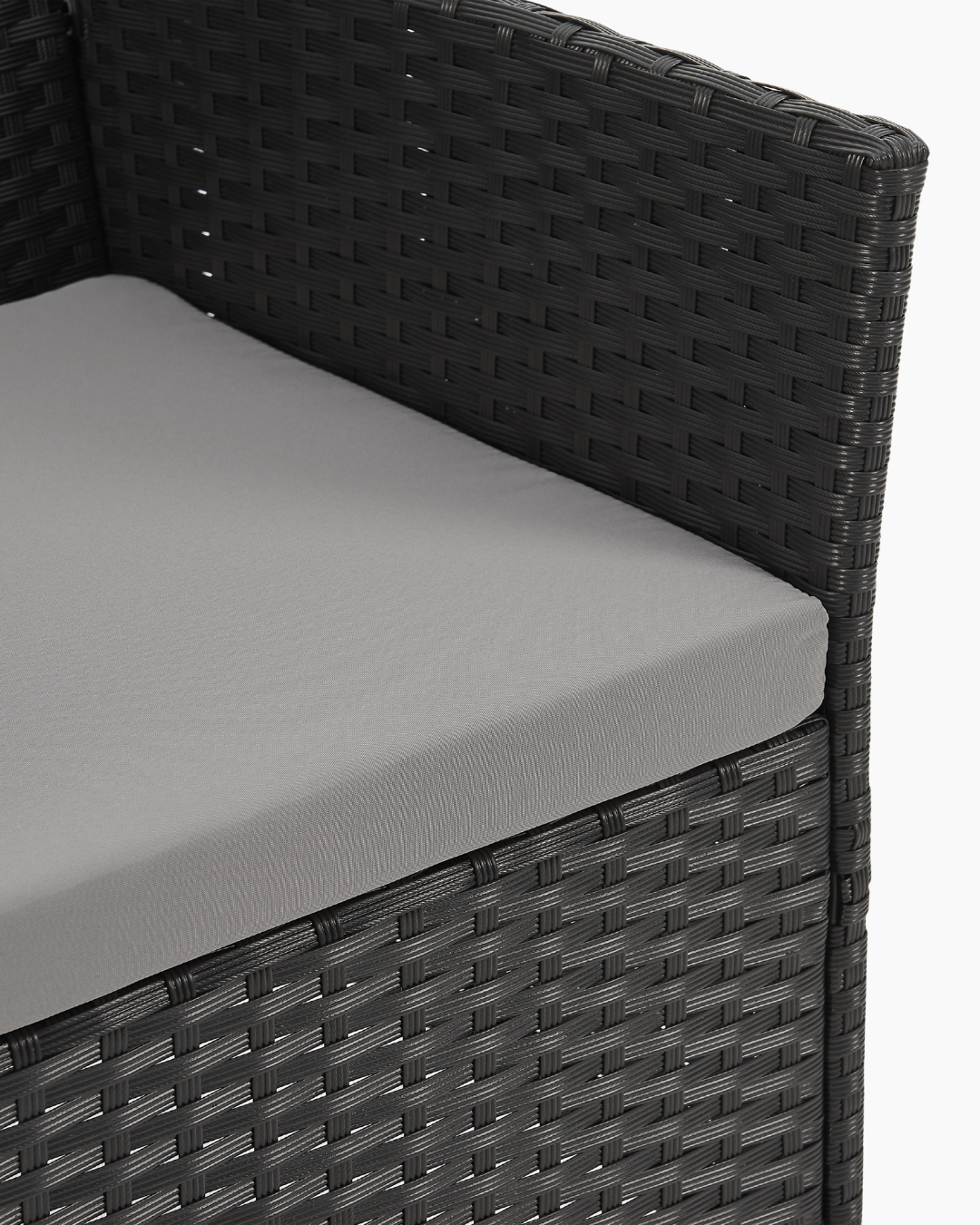 Gray cushion on a black wicker chair