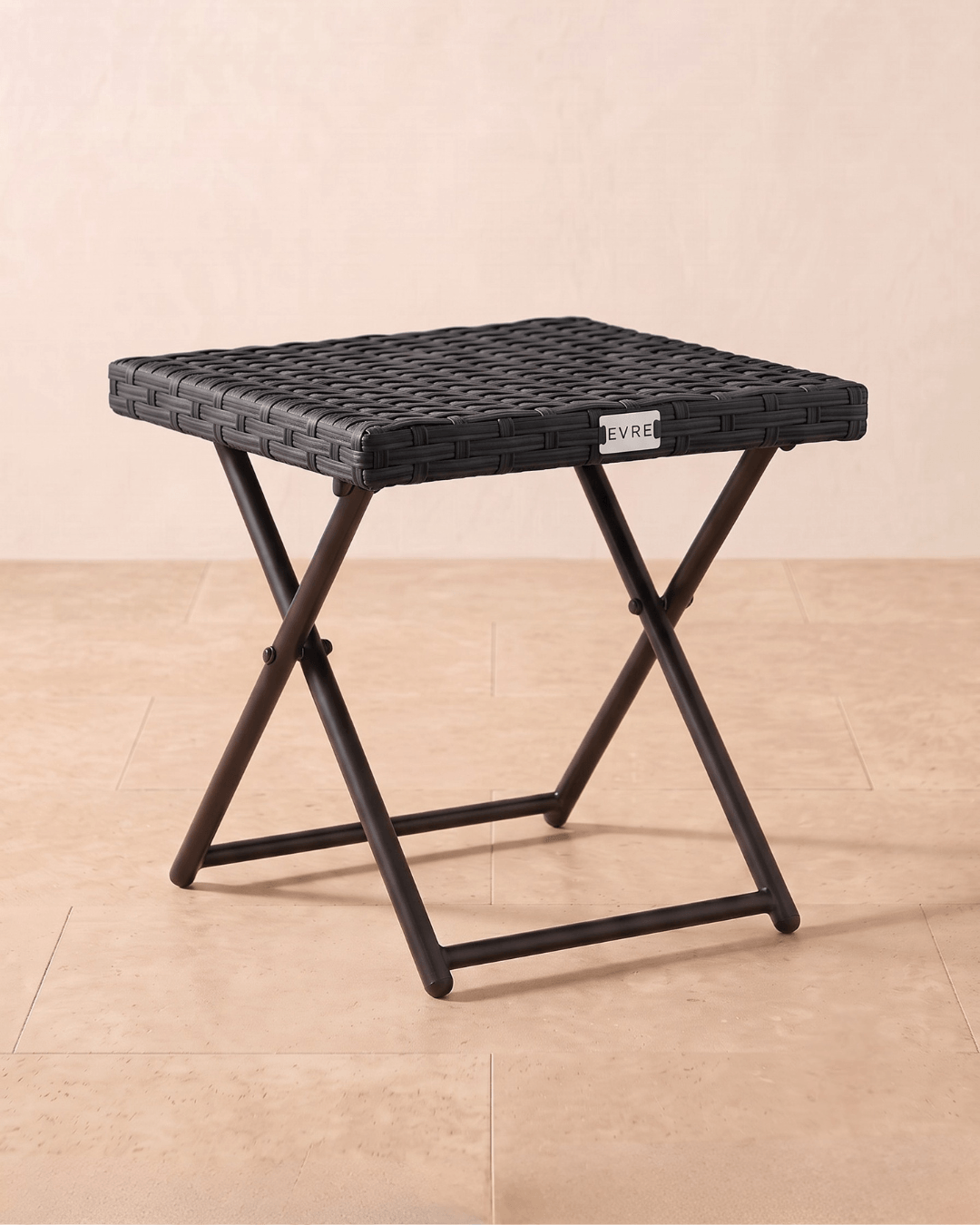 A garden bistro table in black woven with a folding metal frame