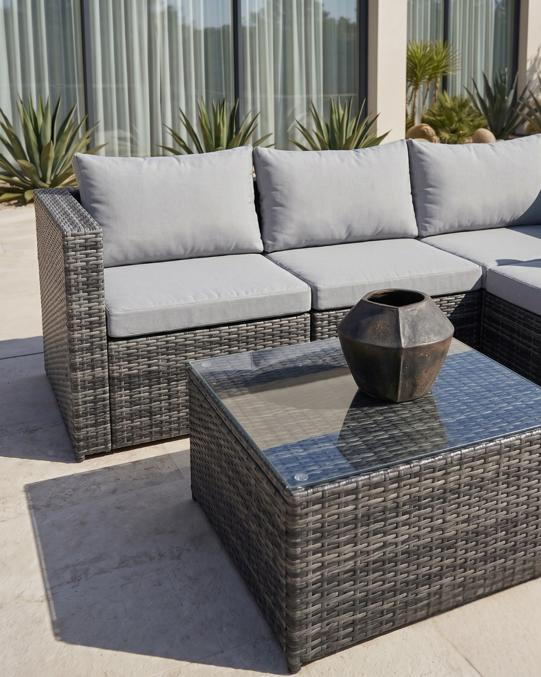 Grey rattan garden sofa with coffee table