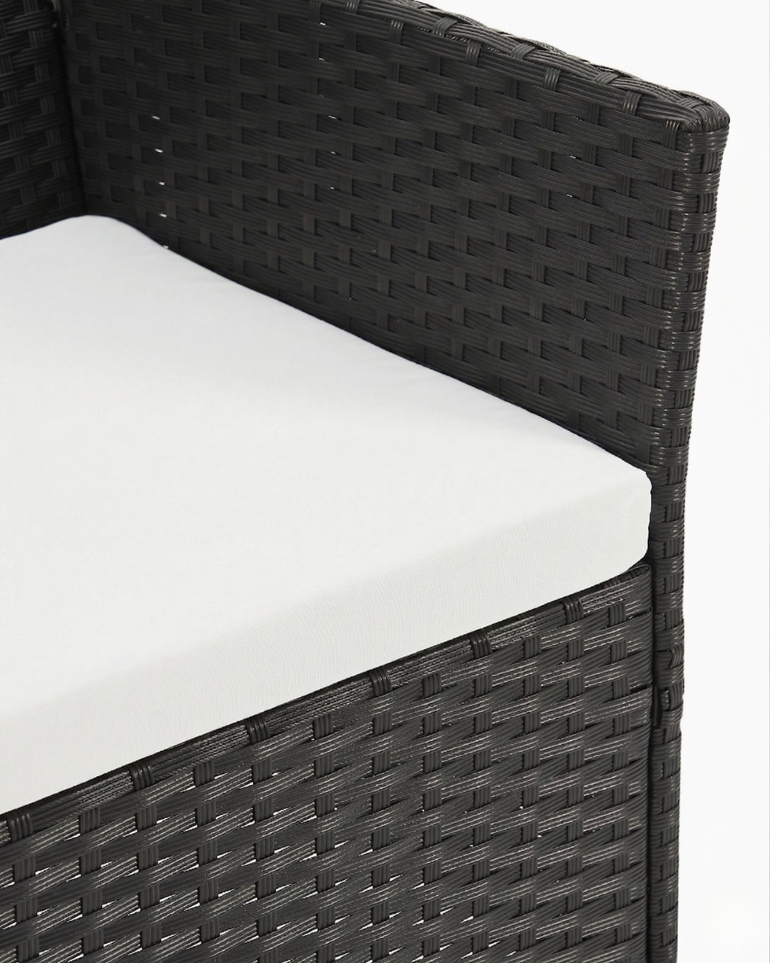 Black wicker chair with white cushion