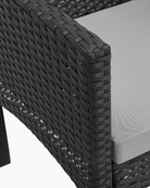 Close-up of a black woven chair with grey seat cushion