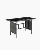Outdoor table with wicker frame and glass top