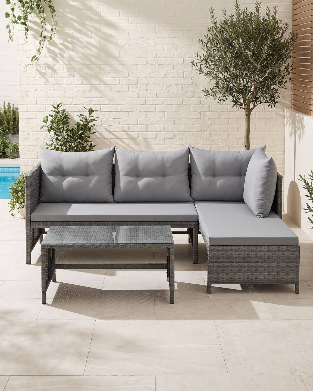 Small garden corner sofa in grey rattan with showerproof cushions