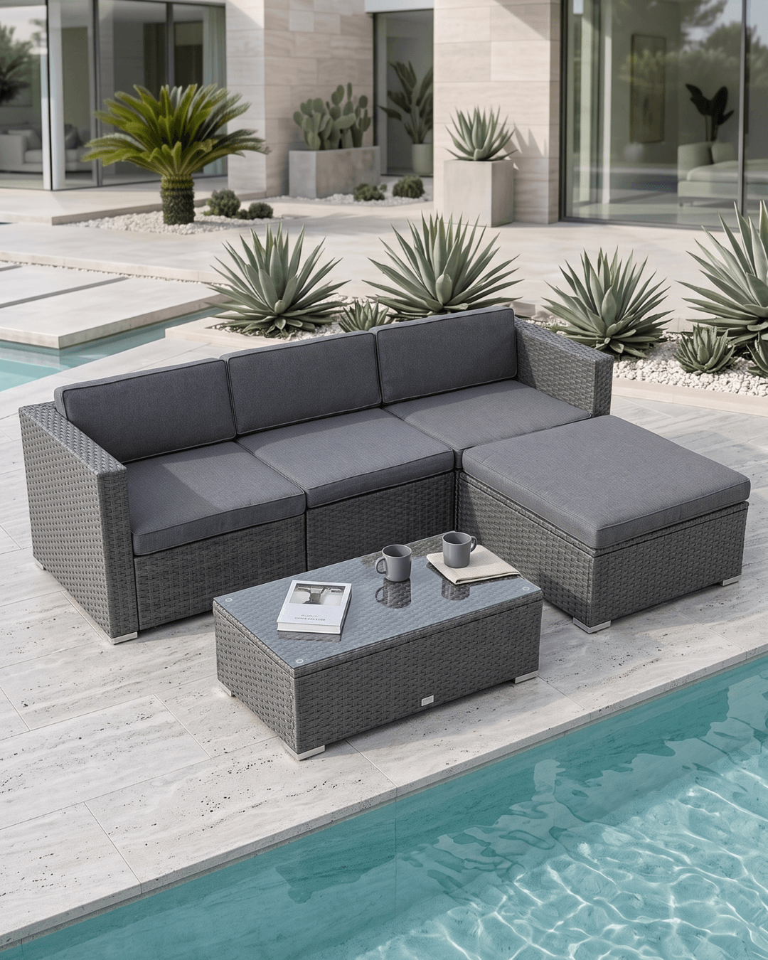 Grey Rattan Garden Corner Sofa Set with Coffee Table on a light stone patio beside a swimming pool