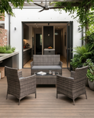 Mixed Brown Outdoor patio set with chairs and table on a wooden deck