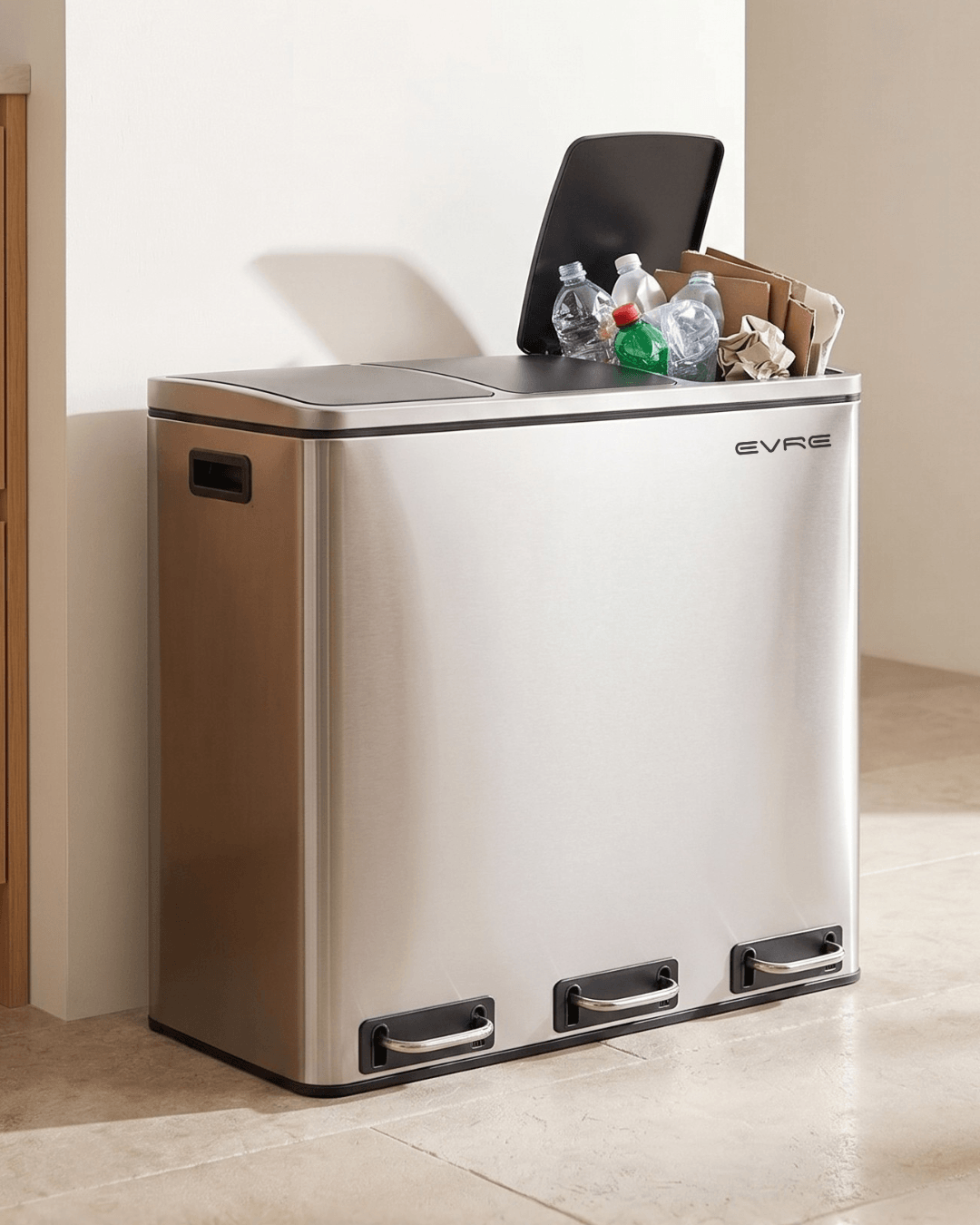 A stainless steel 3 compartment recycling bin shown in a clean kitchen setting