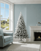 5ft snowy Christmas tree in a living room by a fireplace and window