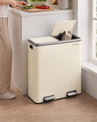 A large cream kitchen bin with an open lid, placed on a wooden floor next to a kitchen counter