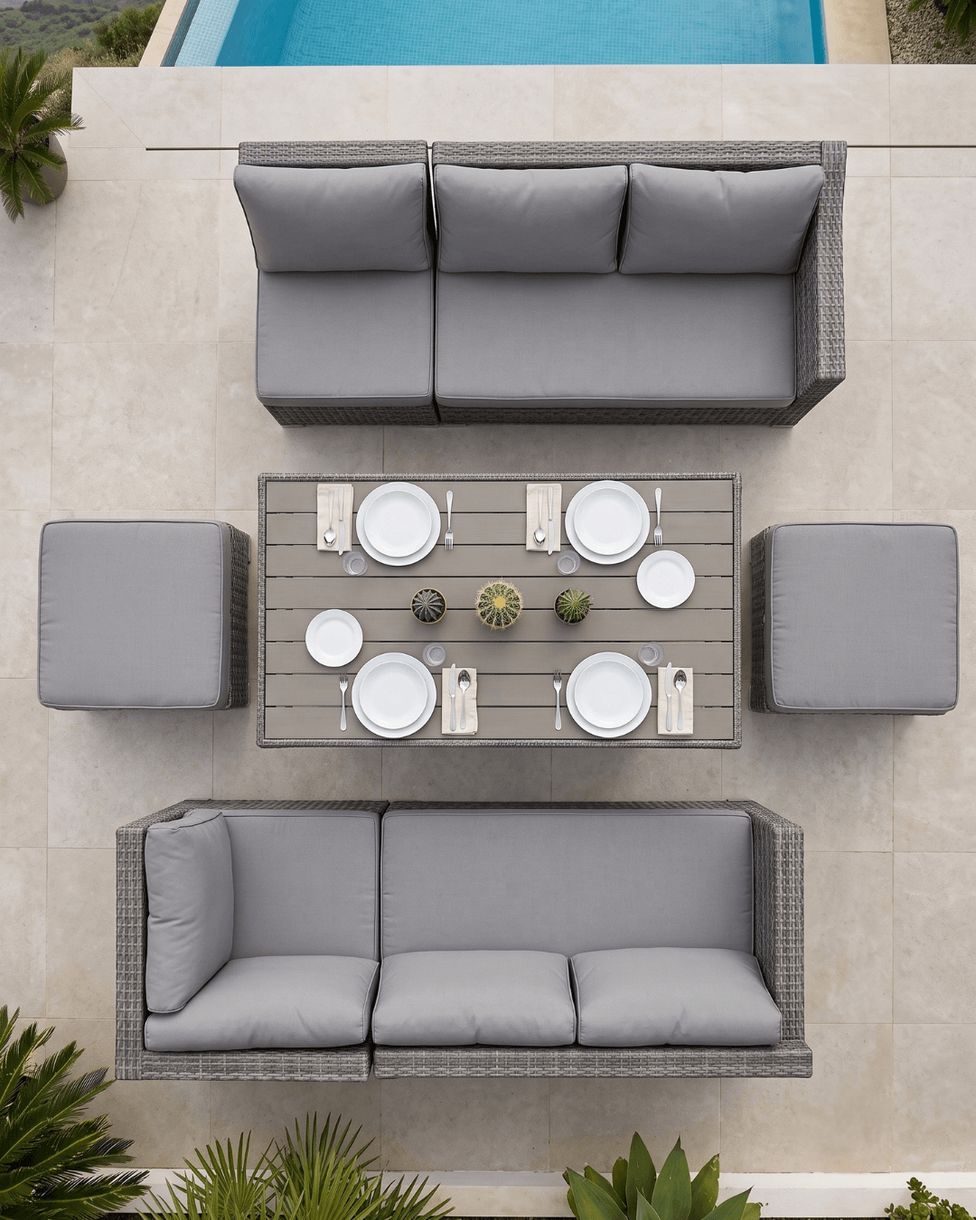 Top-down view of a 7-piece rattan garden furniture set on a light beige tiled patio