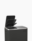 Black trash bin with lid that opens fully