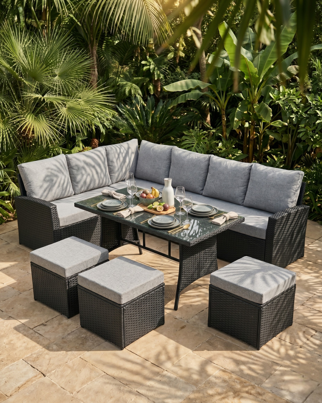 9 Seater Rattan Garden Furniture Set Black on a stone patio surrounded by greenery