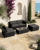 Black rattan modular garden furniture with cushions outdoors