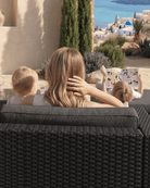 Black wicker outdoor sofa with thick cushions