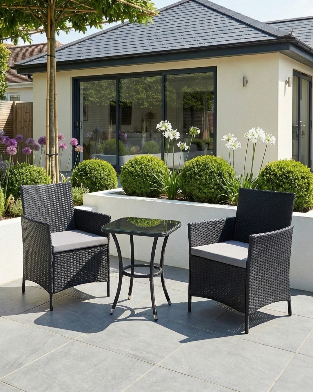 Outdoor patio set with two chairs and a table on the patio