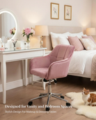Pink swivel chair in a bedroom with vanity table and bed