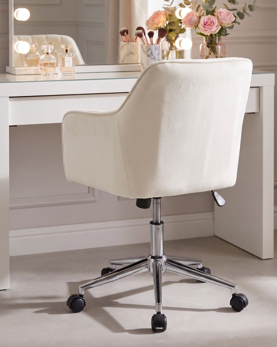 White swivel chair in front of a white vanity