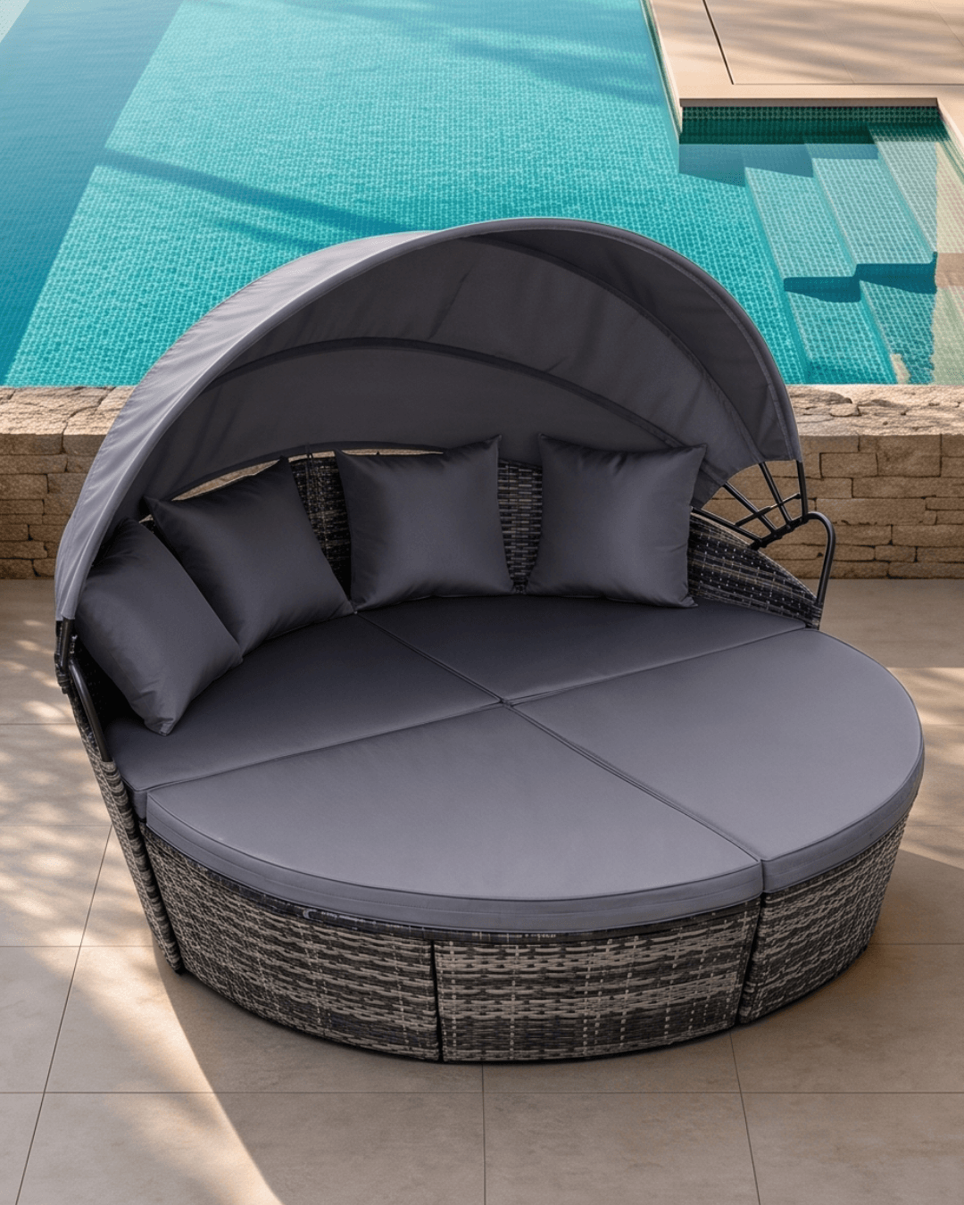 Round outdoor daybed with canopy on a patio with ocean view