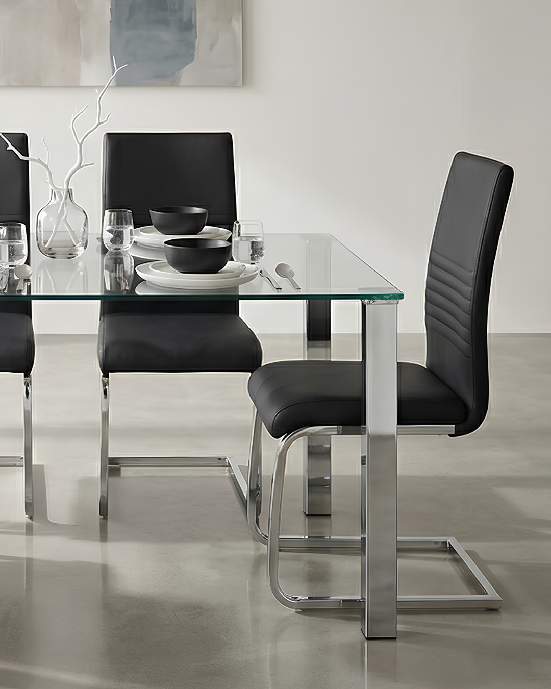 A pair of faux leather black dining chairs in a modern dining room