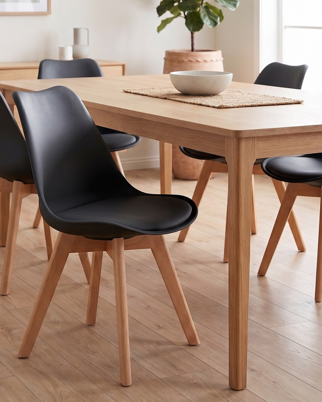 Dining table with black chairs in a well-lit room