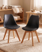Two black chairs with wooden legs in a nursery room