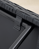 Close-up detail of a collapsible garden bistro table with black rattan tabletop