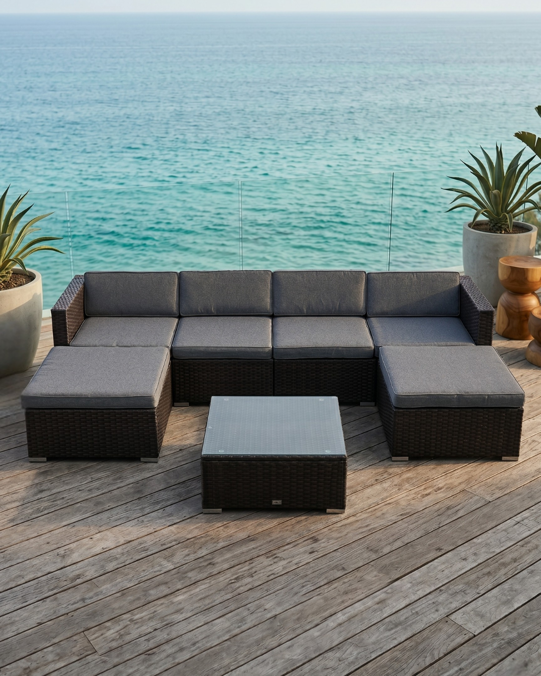 Brown rattan sofa outdoor on a wooden deck by the ocean