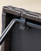 Close-up detail of a small rattan garden table with brown rattan tabletop