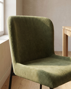 Detailed view of the green corduroy fabric with sculpted contours and texture, showcasing stain-resistant upholstery