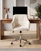 Velvet upholstered white office chair in front of a wooden desk