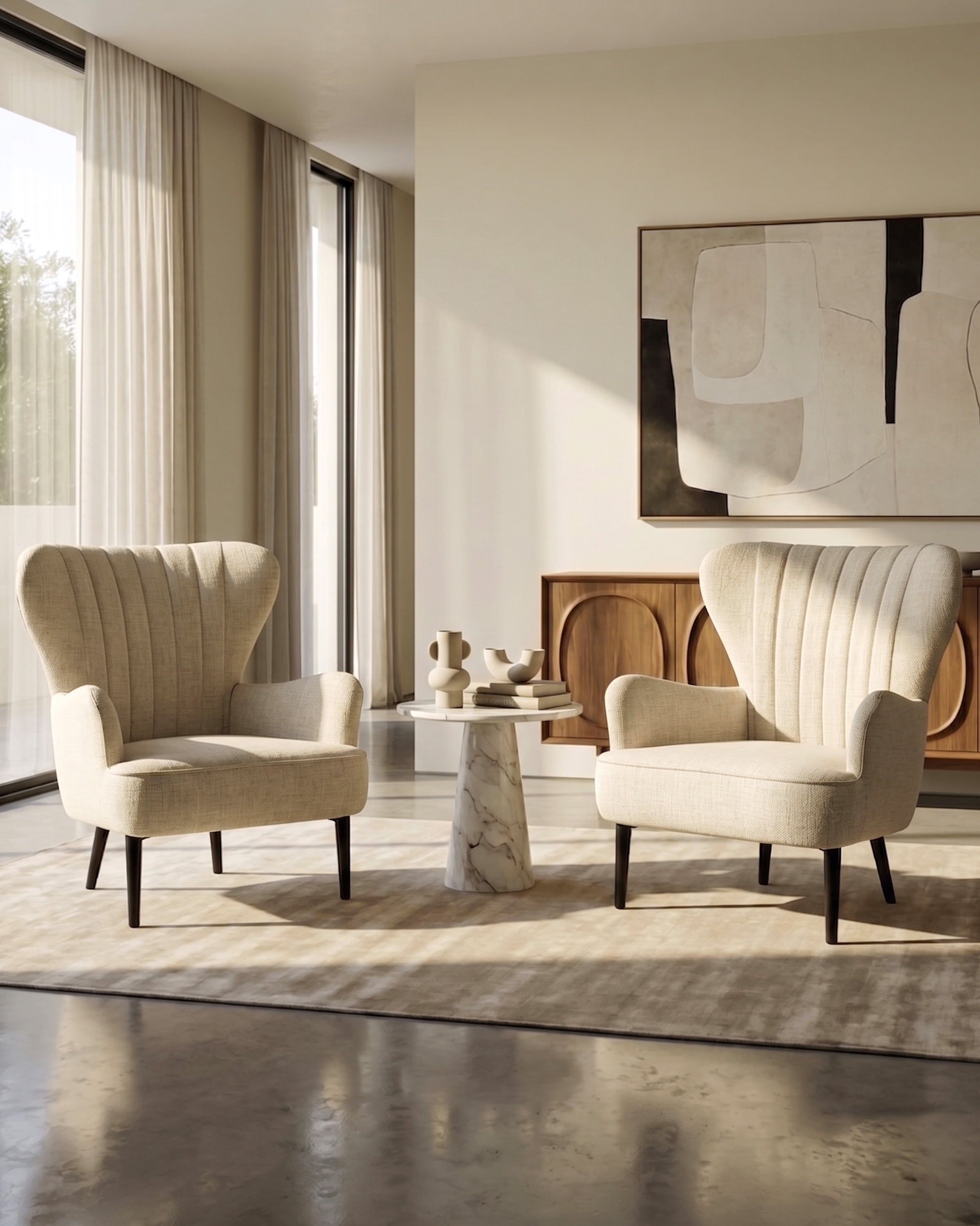 Modern living room with two cream-colored armchairs, a marble side table, and abstract art on the wall