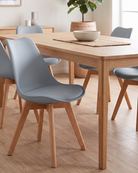 Dining room with wooden table and grey chairs on a wooden floor
