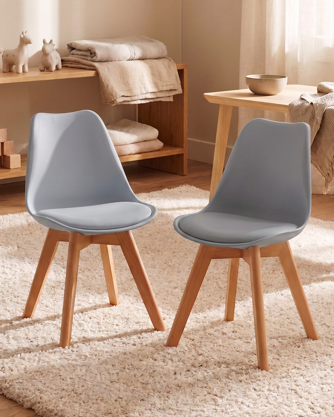 Two grey tulip chairs with wooden legs