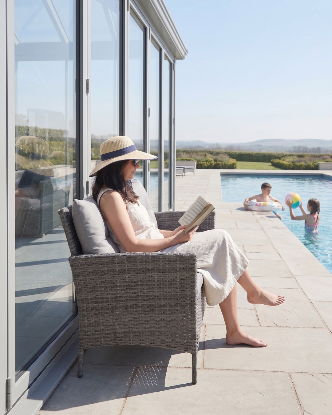 Grey garden loveseat by the pool
