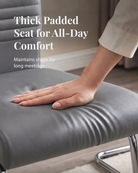 Hand resting a hand on a thick padded grey chair seat