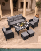 6-piece large outdoor patio dining set with a three-seater sofa, two armchairs, a rectangular coffee table, and two ottomans
