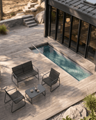 Modern black metal outdoor lounge set with a spacious double sofa, two garden chairs, and a coffee table