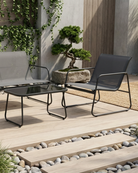 Black outdoor lounge set on a wooden deck