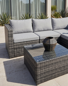 Grey rattan garden sofa with coffee table