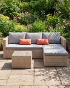 Full view of Malibu garden furniture set showing spacious, sturdy rattan frame in a vibrant backyard environment