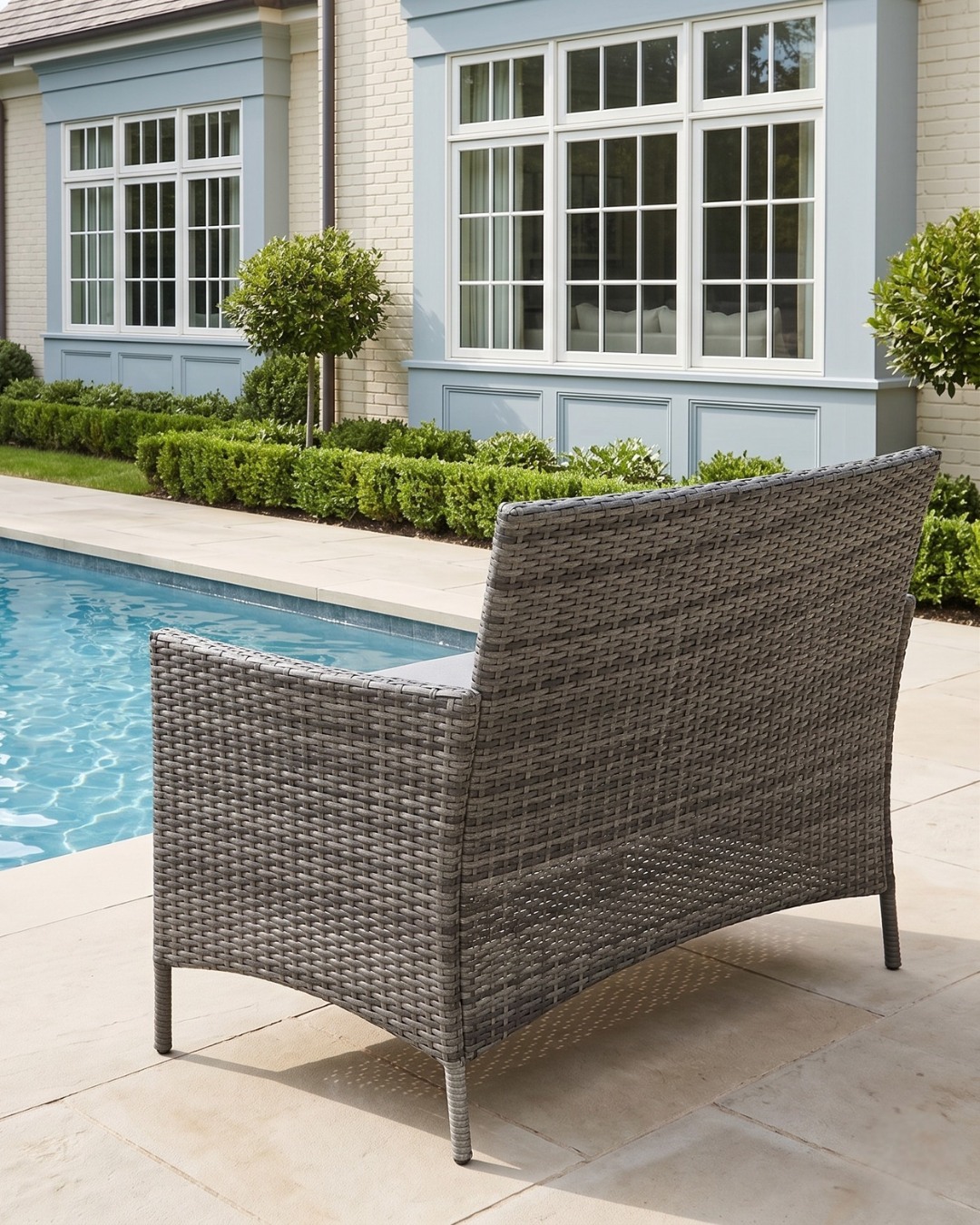 Grey Wicker garden sofa by a pool