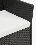 Black wicker chair with white cushion 