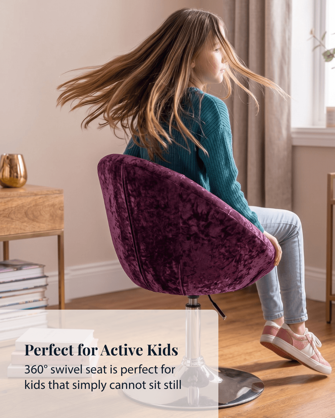 Girl twirling round in a pink velvet swivel chair in a bright room