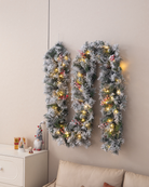 Christmas garland with LED lights on a wall above a sofa