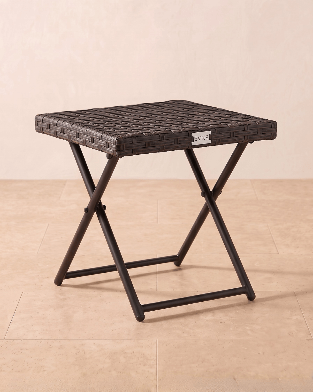 A square small rattan garden table with a folding metal frame