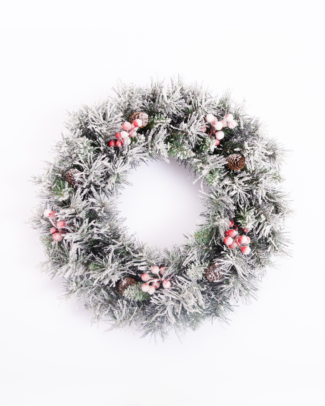 Snow-flocked Christmas wreath with artificial berries and pinecones